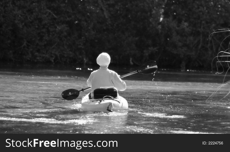 Photo image of a woman in a kayak going up stream in Weeki Wachee Springs. Photo image of a woman in a kayak going up stream in Weeki Wachee Springs.