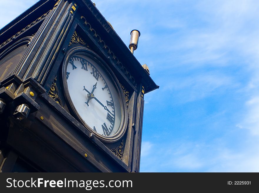 Ancient hours on a background of the blue sky