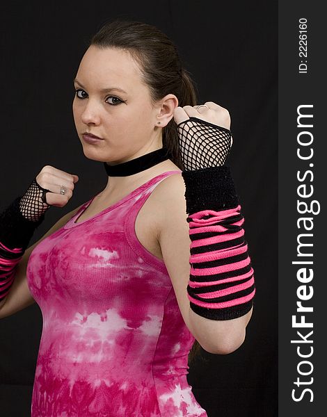 A young woman in a pink top looking aggresively towards camera. A young woman in a pink top looking aggresively towards camera