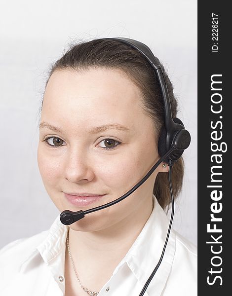 A smiling girl wearing a telephone headset. A smiling girl wearing a telephone headset