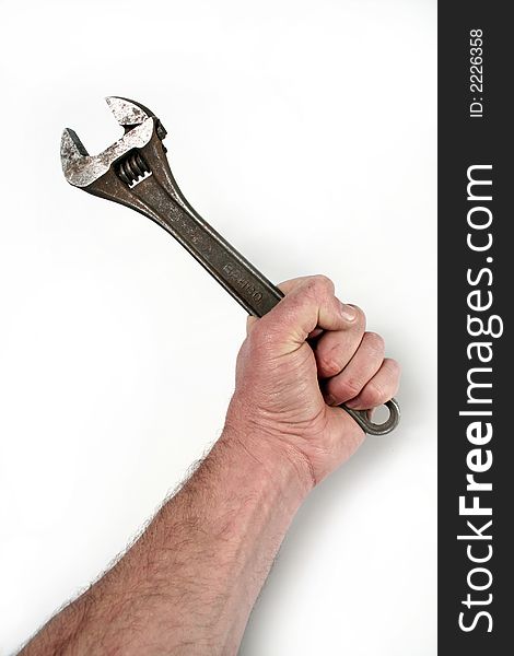 A hand clutching a monkey wrench on a white background. A hand clutching a monkey wrench on a white background.