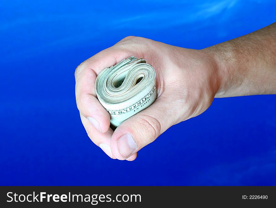 Dollar banknotes in hand on blue background. Dollar banknotes in hand on blue background