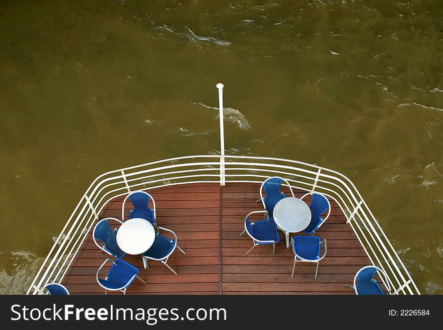 Tables and chairs on cruise ship terrace