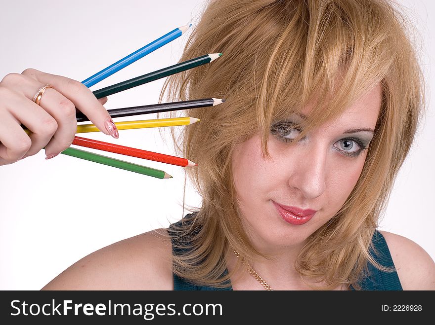 The girl with pencils on a white background