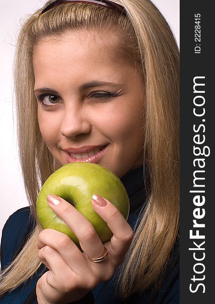 The girl with an apple on a white background