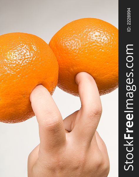 Two colorful oranges on fingers. Two colorful oranges on fingers