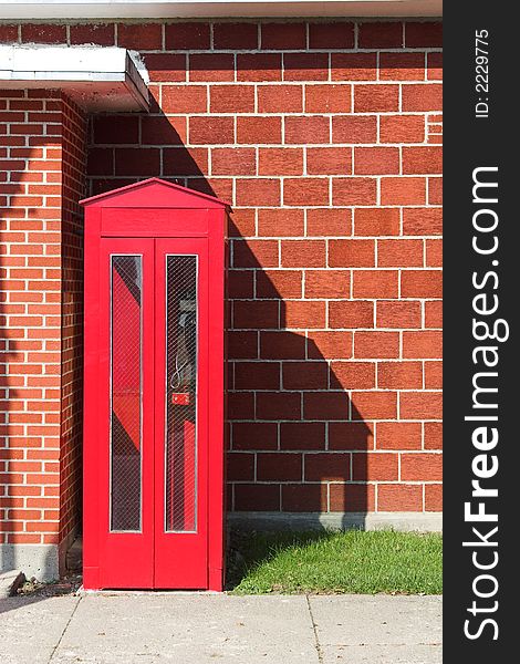 A vintage red phone booth. A vintage red phone booth.