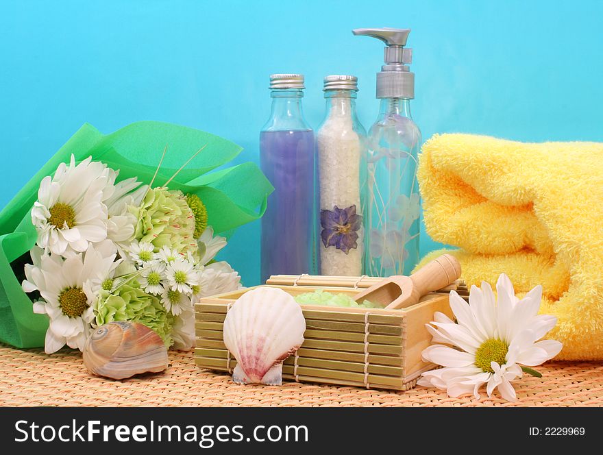 Bath Salts With Soap and Flowers on Blue Background. Bath Salts With Soap and Flowers on Blue Background