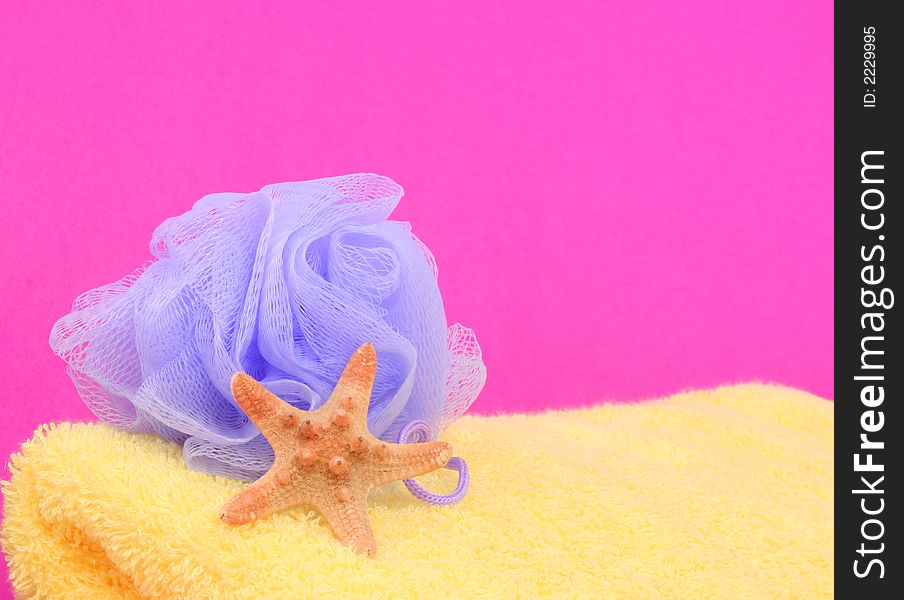 Sponge and Towel With Starfish on Pink Background