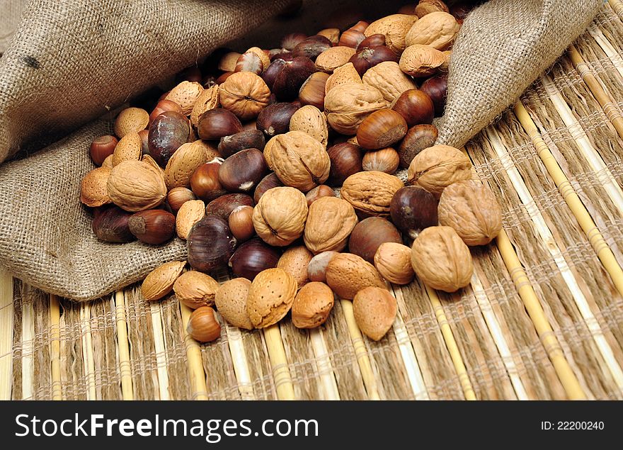Hazelnuts, walnuts, chestnuts and almonds in jute sack. Hazelnuts, walnuts, chestnuts and almonds in jute sack