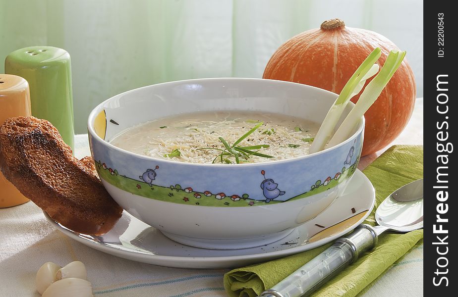 Soup of mashed potatoes from a pumpkin with crackers and grated cheese. Soup of mashed potatoes from a pumpkin with crackers and grated cheese