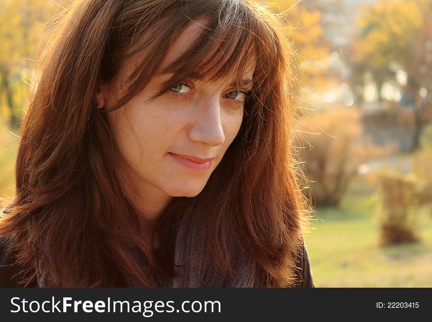 Portrait of a young woman, depicting content and inner happines, taken in the park in the autumn,. Portrait of a young woman, depicting content and inner happines, taken in the park in the autumn,