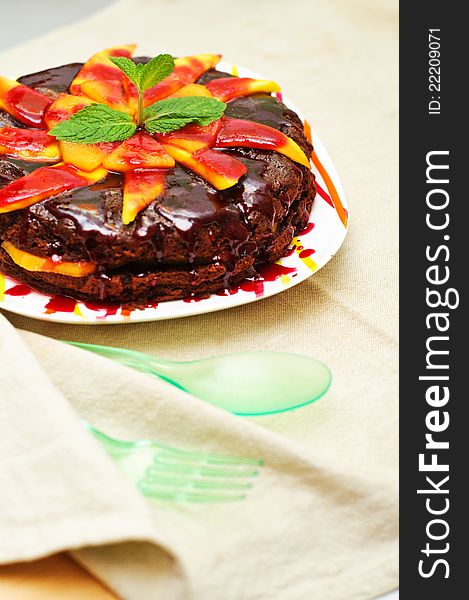 Chocolate brownie with persimmon and mango and pomegranate sauce. Chocolate brownie with persimmon and mango and pomegranate sauce