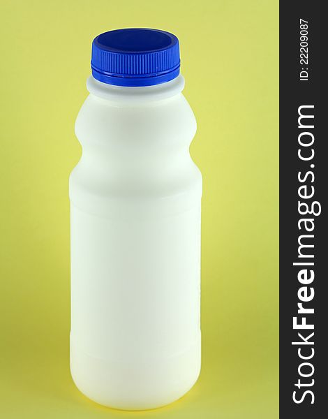 A bottle of fresh Pasteurized Milk on a yellow background