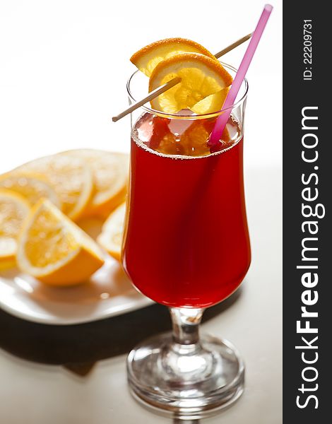 Photograph of a cranberry cocktail with oranges