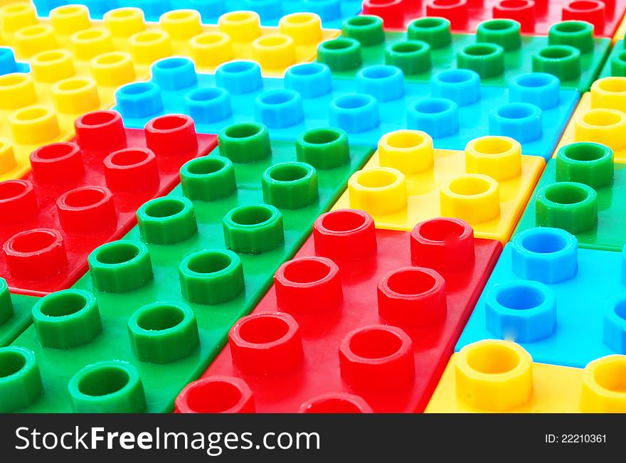 Multi-colored children's lego as a background. Multi-colored children's lego as a background