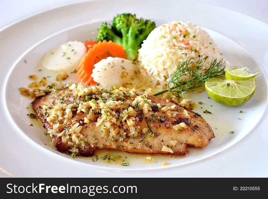 Roasted fish served with fried rice. Roasted fish served with fried rice