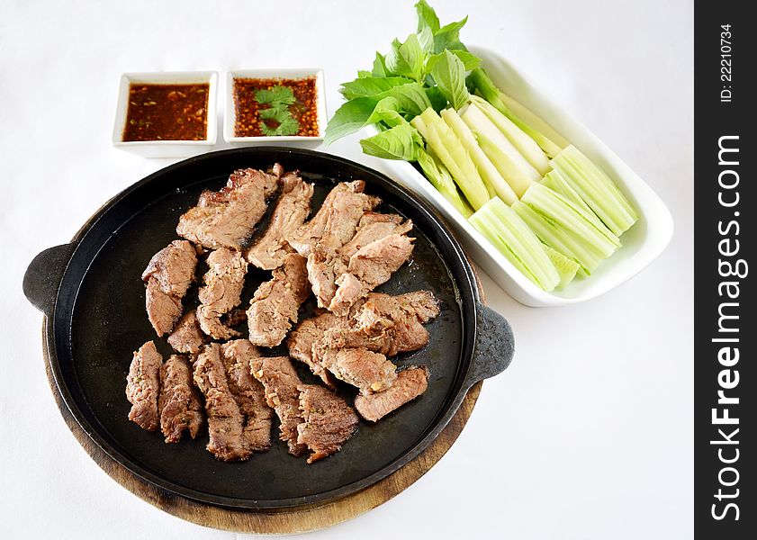 Roasted beef fillet on a hot plate ,served with vegetable