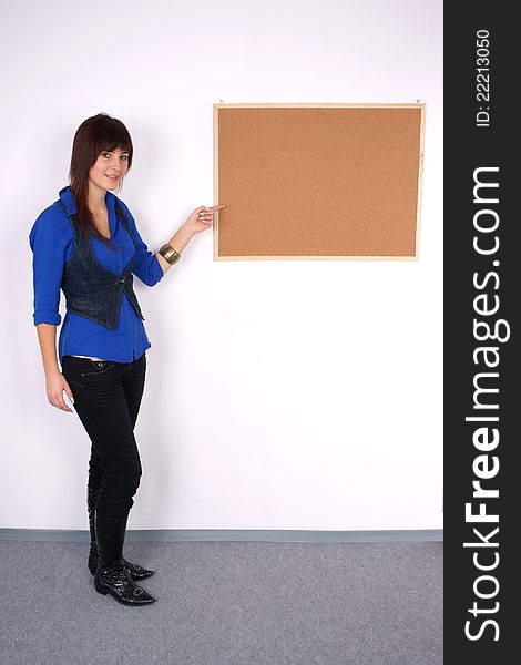 Beautiful woman pointing at the board. Full body shot.