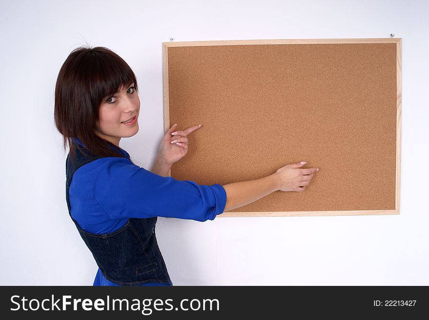 Pretty woman pointing at the pin board. Close up.