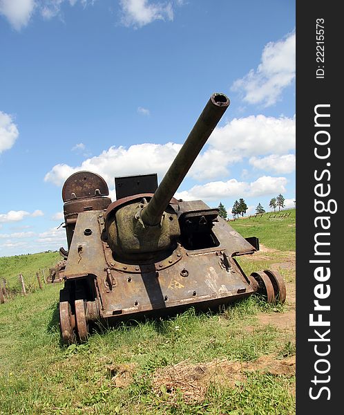 An old Soviet tank lined under the peaceful blue sky. An old Soviet tank lined under the peaceful blue sky