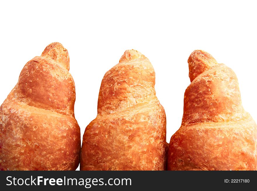 Background three fresh croissants, with a golden crust. Background three fresh croissants, with a golden crust