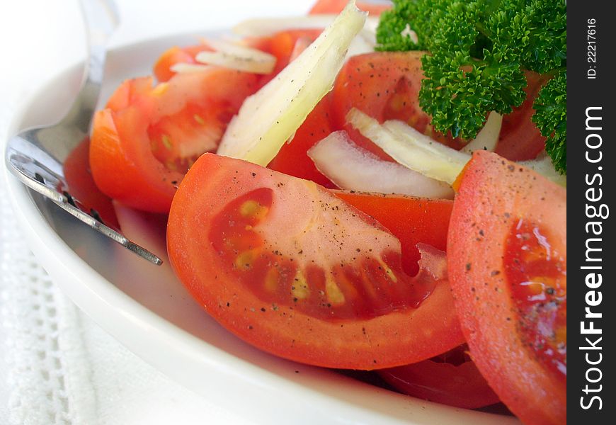 Fresh tomatoes salad with onion close up