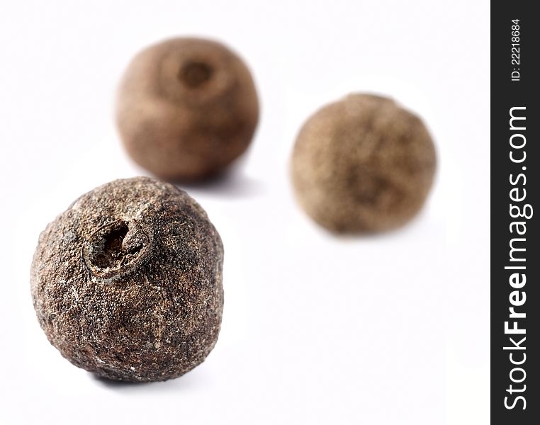 Closeup of allspice seed over white background