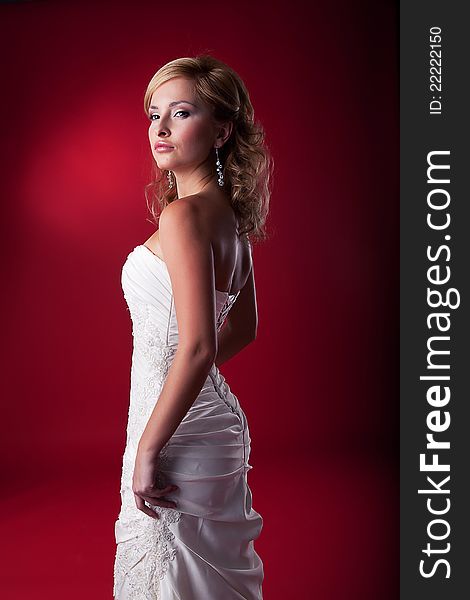 Fiancee - beautiful blonde fashion model in wedding white dress standing. Series of photos. Fiancee - beautiful blonde fashion model in wedding white dress standing. Series of photos