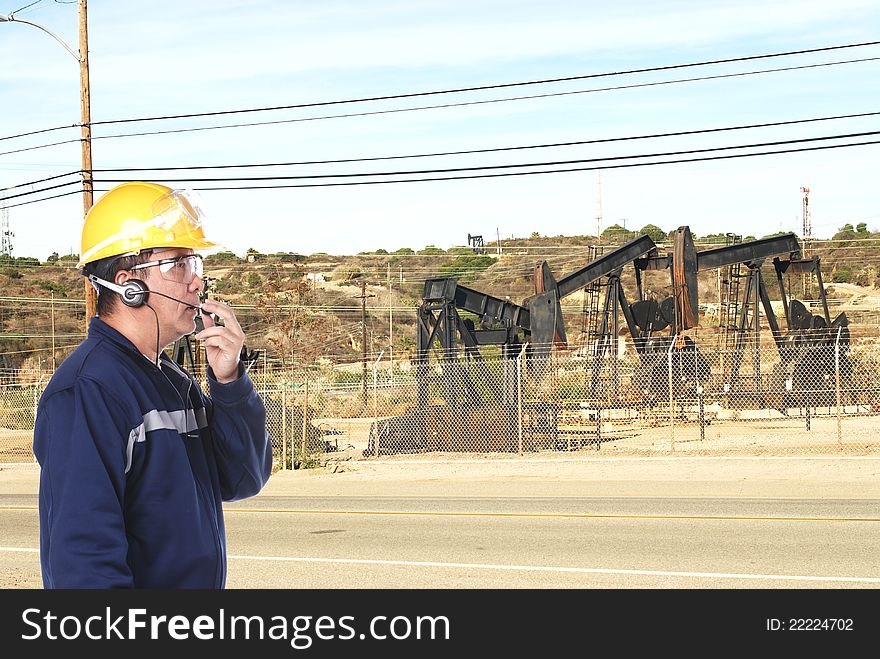 Oil field worker with yellow hardhat