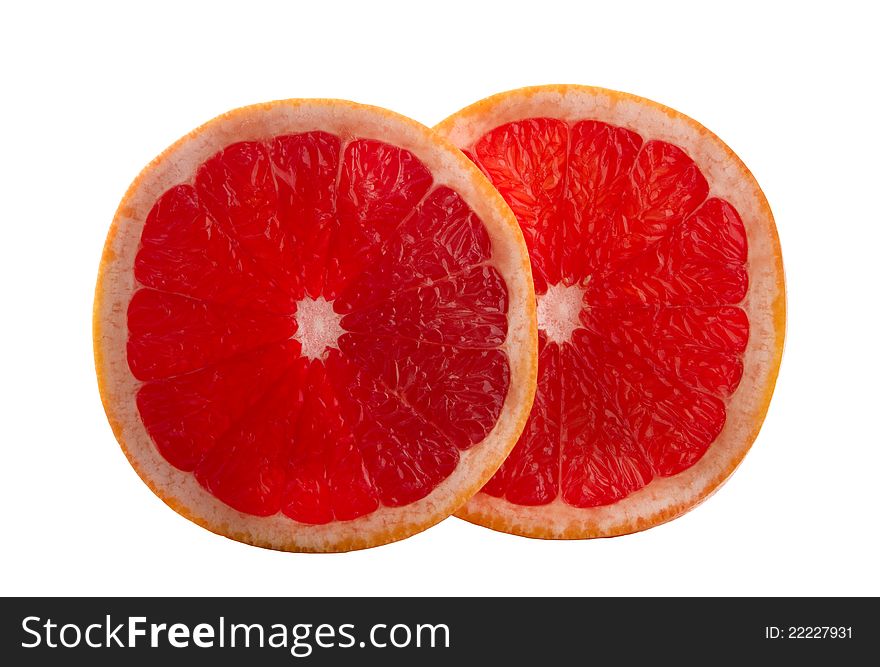 Two slices of grapefruit, isolated on white background.