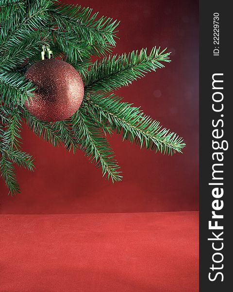 Christmas decoration. Fur-tree branch, red ball. Christmas card