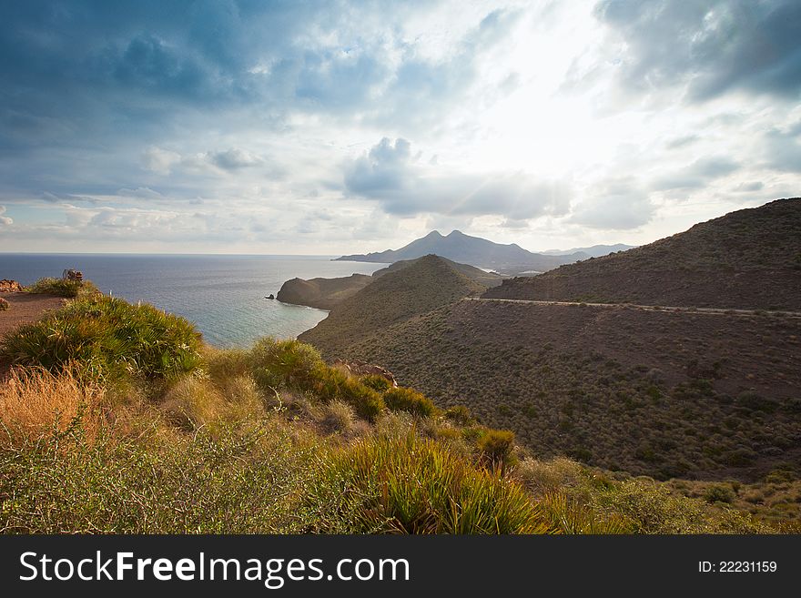 Almería´s landscape offers dry hills covered with scrubs while the narrow valleys offer a fertile volcanic soil having always the blue mediterranean sea in the background. Almería´s landscape offers dry hills covered with scrubs while the narrow valleys offer a fertile volcanic soil having always the blue mediterranean sea in the background.