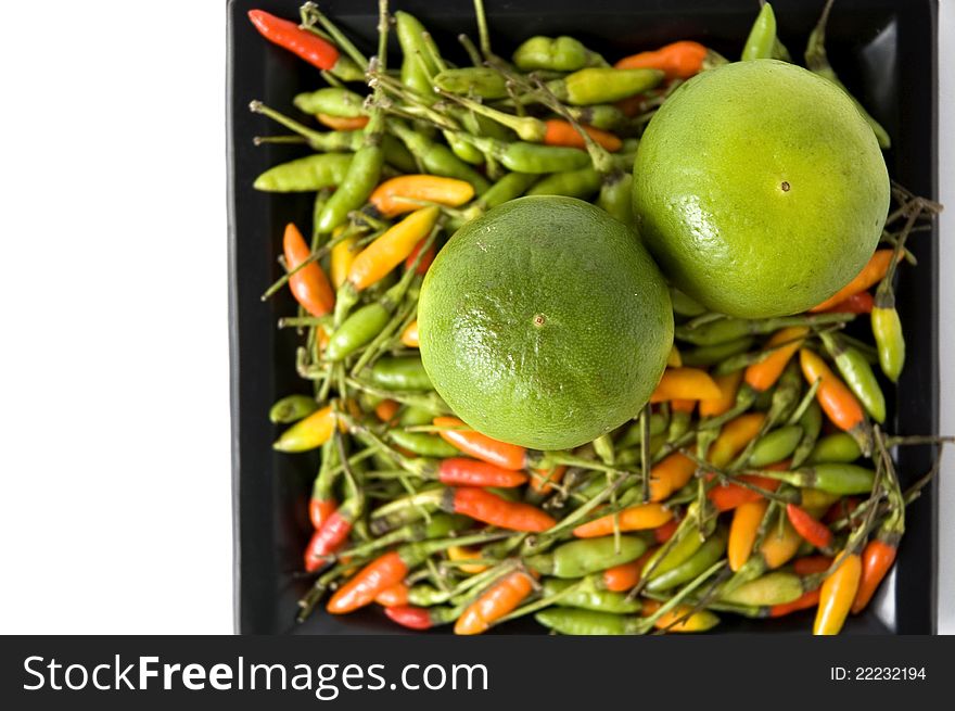 Lime on colorful chili with white background beside