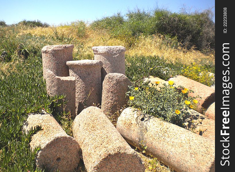 Pile of ancient and weathered sections of Roman columns. In the ruined city of Caesarea, Israel. Pile of ancient and weathered sections of Roman columns. In the ruined city of Caesarea, Israel.
