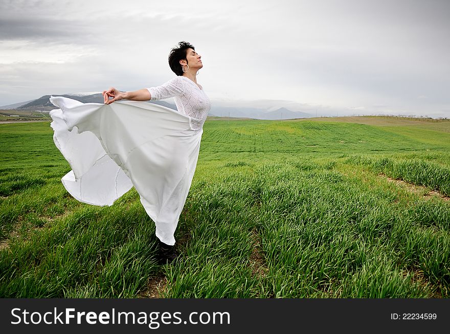 Woman Wearing A Wedding Dress In The Meadow