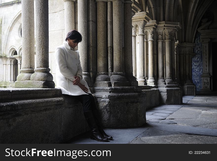 Woman meditating in the cloister of a convent in Salamanca, Castilla León, Spain