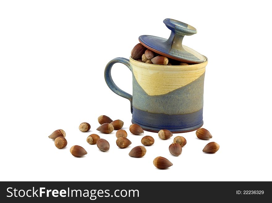 Hazelnut and ceramic mug on white background