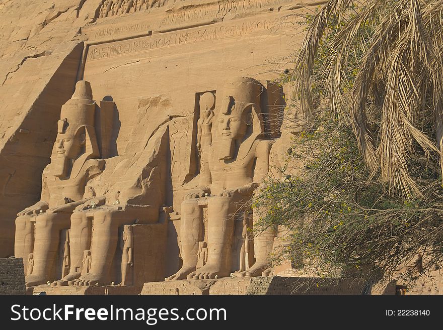 Abu Simbel Temple of King Ramses II (Egypt) The view from behind the palm trees. Abu Simbel Temple of King Ramses II (Egypt) The view from behind the palm trees.