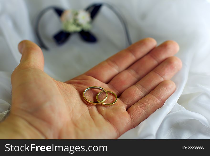 Gold wedding rings on a mans palm. Gold wedding rings on a mans palm