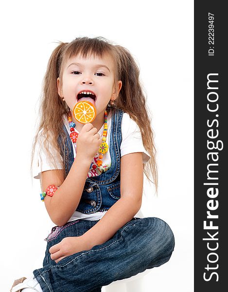Cute happy little girls tasting brigh lollipop