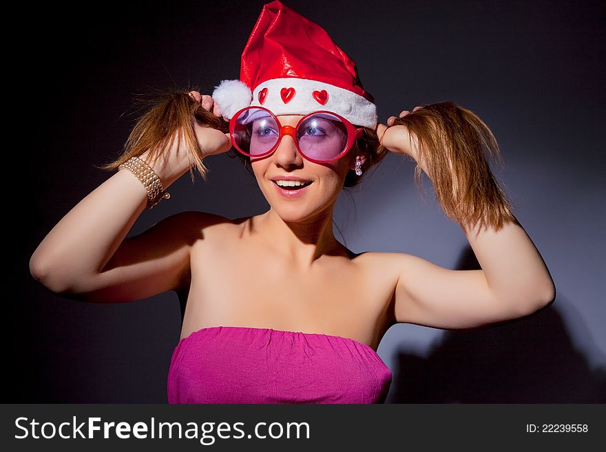 Smiling female santa over dark background