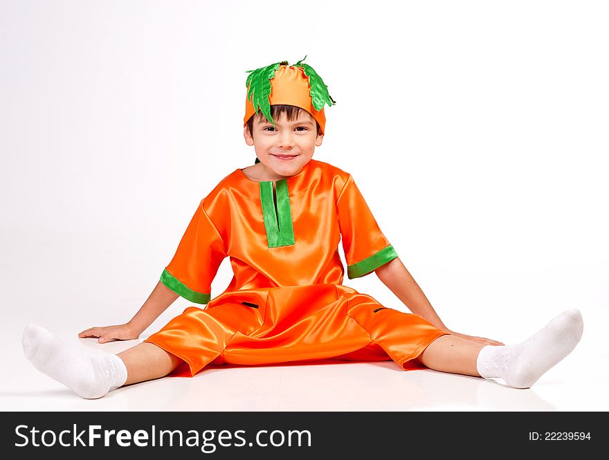 Image of a smiling boy wearing carrot fance dress. Image of a smiling boy wearing carrot fance dress