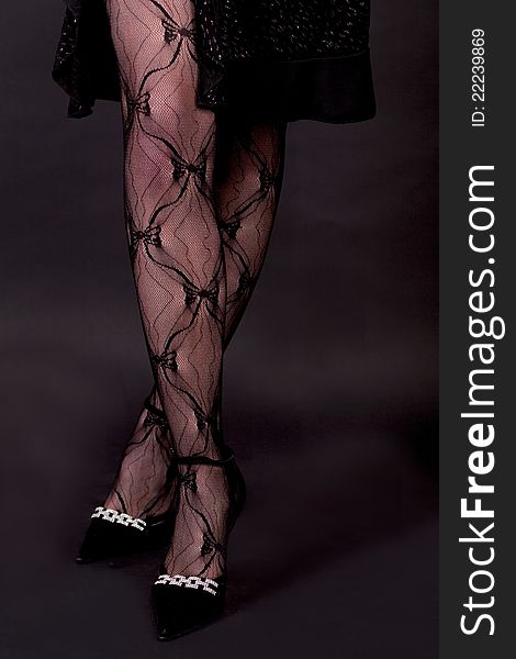 Female sexy legs over dark background