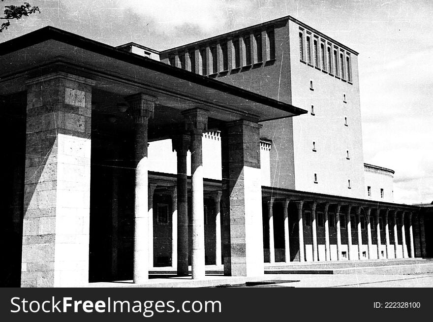 The Ankara Opera Building, which hosts performances by the Ankara State Opera and Ballet and Ankara State Theater was designed and built as an exhibition center and only later converted into an opera house. In 1933 the National Economy Community opened an international competition for the building stating that it had to be in modernist style. A proposal by Şevki Balmumcu received first prize and construction went ahead between 1933 and 1934. In 1948 Paul Bonatz converted the building into an opera house and his addition of traditional Turkish architectural details made it more “national.” Balmumcu was not consulted about the building’s renovation, which disappointed and professionally disturbed him for years to come. In the garden of the building there are sculptures of Leyla Gencer, Cüneyt Gencer and Muhsin Ertuğrul.

SALT Research, Harika-Kemali Söylemezoğlu Archive


Günümüzde hem Ankara Devlet Opera ve Balesi temsillerine ev sahipliği yapan hem de Büyük Tiyatro adıyla Ankara Devlet Tiyatrosu için bir sahne olarak hizmet veren Ankara Opera Binası, ilk olarak bir sergi sarayı olarak inşa edildi, daha sonra opera binasına dönüştürüldü. Binanın tasarımına, Milli İktisat ve Tasarruf Cemiyeti’nin 1933’te açtığı uluslararası bir yarışma sonunda karar verildi. Yarışmanın duyurusunda, tasarımın modernist üslupta olması gerektiği özellikle belirtildi. Birinci seçilerek mimarı Şevki Balmumcu’ya büyük bir prestij kazandıran proje 1933-1934 yıllarında uygulandı. Paul Bonatz, 1948’te binayı işlevinden çok farklı olarak bir opera binasına çevirdi; Geleneksel Türk Mimarlığı’ndan detaylar ekleyerek binayı “millîleştirdi”. Tasarladığı binanın kendisine hiç danışılmadan, dönemin eğilimi olan İkinci Ulusal Mimarlık’a uygun hâle getirilmesi, Balmumcu’yu mesleki anlamda olumsuz etkiledi. Caddeye paralel uzanan ve birbirini dik kesen iki kitleden oluşan binanın bahçesinde Leyla Gencer, Cüneyt Gencer ve Muhsin Ertuğrul’un heykelleri bulunmaktadır.

SALT Araştırma, Harika-Kemali Söylemezoğlu Arşivi

Repository: SALT Research

Rights Info: This material can be used under Creative Commons Attribution-NonCommercial-NoDerivatives 4.0 International &#x28;CC BY-NC-ND 4.0&#x29; license.