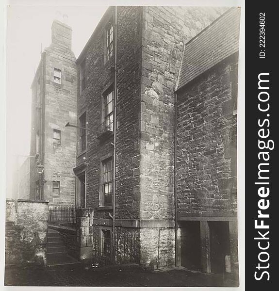 Cobbled Court Area With A Three Storey Building