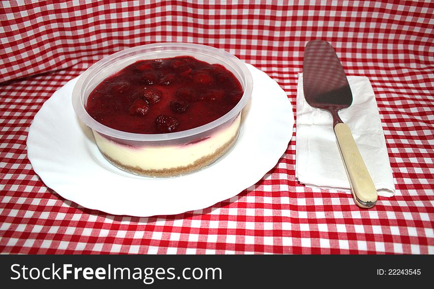 This photo shows a delicious Strawberry Cheesecake just asking to be eaten!. This photo shows a delicious Strawberry Cheesecake just asking to be eaten!