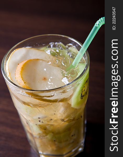 Fruits and ice mixed in a glass with straw. Fruits and ice mixed in a glass with straw