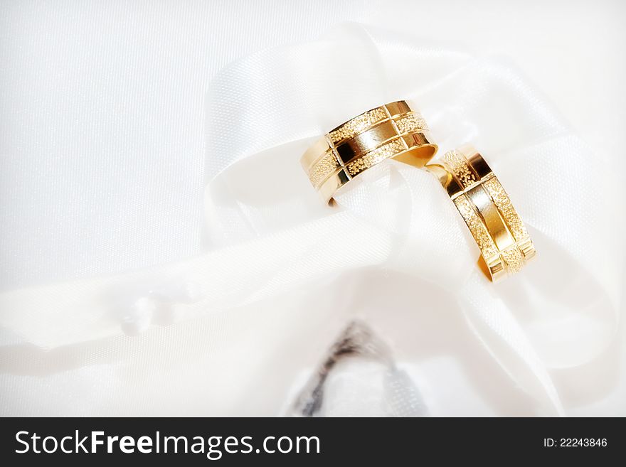 Two gold wedding rings on white background. Two gold wedding rings on white background