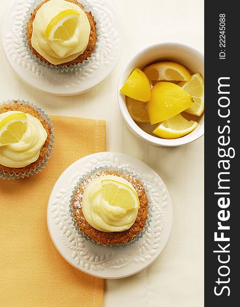 Fresh tasty home-made muffins with lemon curd decorated on white plates